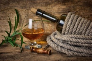 9278903-bottle-of-wine-wrapped-with-rope-on-the-background-of-the-old-wooden-planks